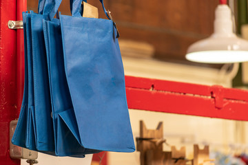 Blue foldable reusable shopping bags for sale at a Market