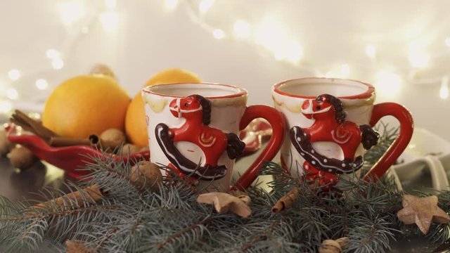 Hot homemade wine being poured in cute decorative mugs on the eve of christmas holiday
(medium shot)