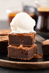 Chocolate brownies with salted caramel, vanilla ice cream. Copy space.
