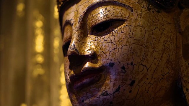 Spiritual textured pattern buddha statue in a low light setting in a temple in India
(moving shot) (slow motion)
