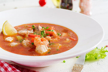 Brazilian food: Moqueca capixaba of fish and bell peppers in spicy coconut sauce  in a plate on a...