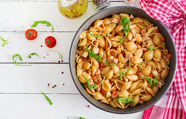 Italian pasta shells with meat and tomato sauce. Conchiglie pasta. Top view
