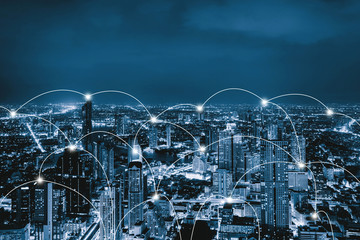 Digital network connection lines of Sathorn, Bangkok Downtown, Thailand. Financial district and business centers in smart urban city in Asia. Skyscraper and high-rise buildings at night.