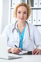 Doctor woman at work. Physician filling up medical history records form at the desk. Medicine, healthcare  concept