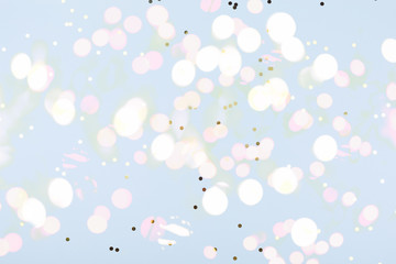 Blue background with gold and dark blue confetti. Christmas and Hanukkah, holiday concept.