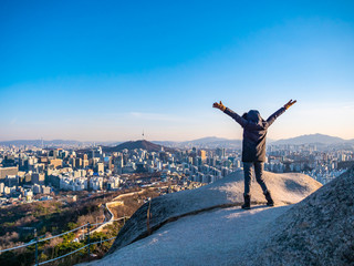 Woman or Girl on the top of mountain with beautiful cityscape Seoul city