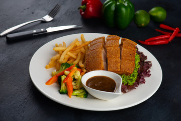chinese crispy pork belly on dark background
