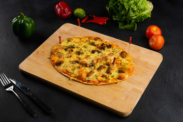 seafood pizza and tomatoes in dark background