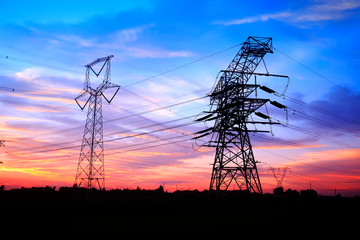 In the evening, the silhouette of high voltage towers