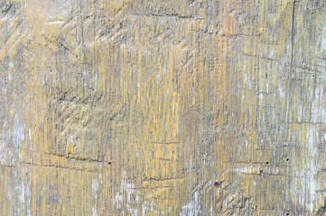 Natural wooden background, distressed with remnants of yellow paint. Organic texture