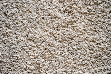 The wall is light brown with a three-dimensional pattern decorated with clay surface. Background