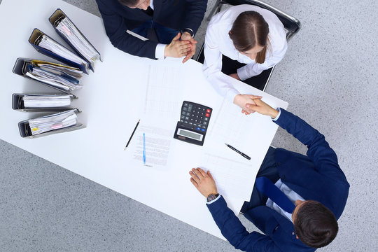 Business People Shaking Hands At Meeting, View From Above. Bookkeeper Or Financial Inspector  Making Report, Calculating Or Checking Balance