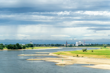 Fototapeta na wymiar River coast and dramatic clouds