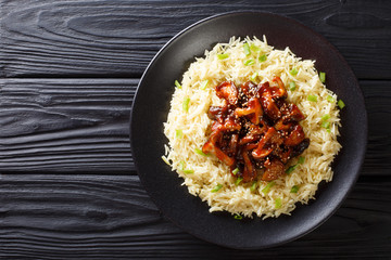 Healthy food glazed shiitake mushrooms with sesame and rice closeup on a plate. horizontal top view