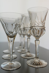Decorative wine and martini glasses are set up in verticle rows displaying  beautiful details of the glass.