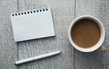 notepad with coffee and pen