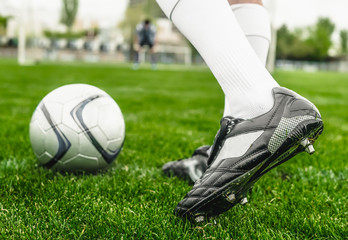 Soccer player with ball on a playing field