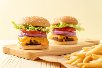 fresh tasty beef burger with cheese and french fries
