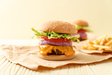 fresh tasty beef burger with cheese and french fries
