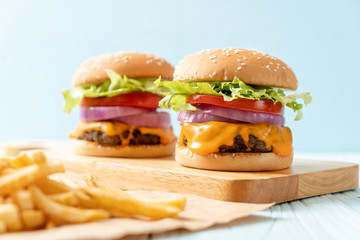 fresh tasty beef burger with cheese and french fries