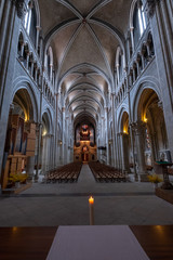 Obraz premium Interior of catholic cathedral, candle at foreground