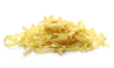 Raw tagliatelle pasta noodles isolated on white background
