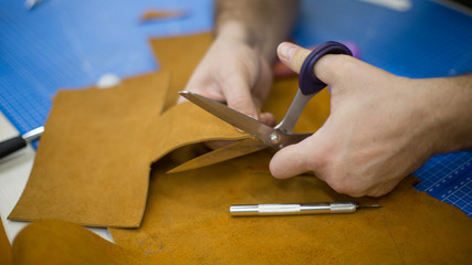 Man working with leather using crafting DIY tools
