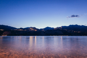 Evening scene at lago di garda: Lake, rocks and village