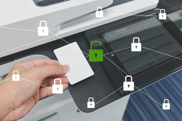 Business man hand is using smart card to printing document with locked and unlocked key icon for data protection concept