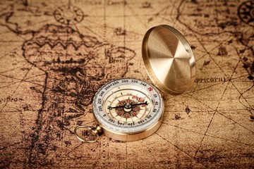 Vintage compass on old world map  - Explore concept