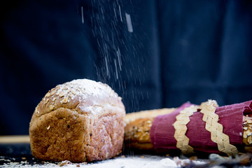 assorted fragrant loaves of bread with flour