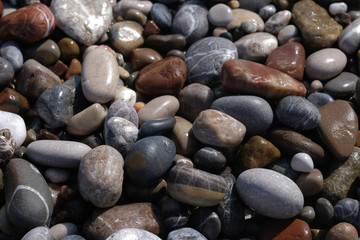 The wet pebbles on the beach.