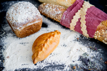 assorted fragrant loaves of bread with flour