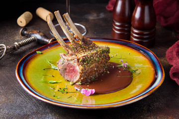 Rack of lamb in breaded pistachio nuts, dark sauce and herbs, pink meat, medium roast © maria_lapina
