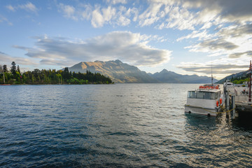 Landscape of boat dock on a lake with beautiful mountain as the background at Queenstown in New Zealand