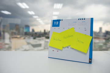Vacation, holiday and leave on paper note stick on the calendar of December for year end holidays...