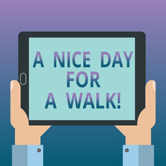 Handwriting text writing A Nice Day For A Walk. Concept meaning Good weather to go outside leisure free relaxing time Hu analysis Hand Holding Blank Screen Tablet Smartphone Display Unit photo