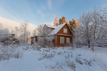 old house in the village in the snow
