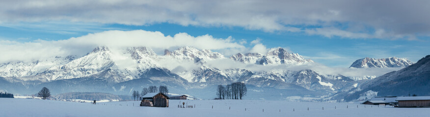 Fototapeta premium Snowy mountains, meadow and a hut, landscape in Austria, panorama