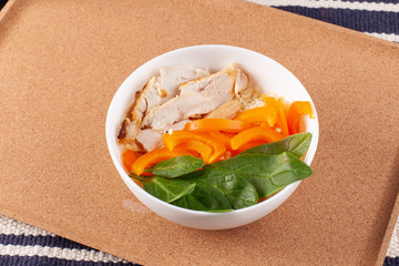 Healthy breakfast with couscous, chicken, pepper, spinach leaves and a cup of coffee