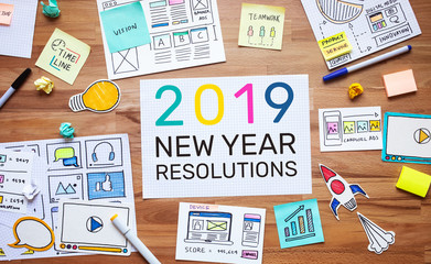 2019 new year resolutions with business digital marketing and paperwork sketch on wood table.analysis strategy concepts