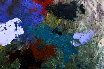 multi-colored strokes of oil paint on the artist's palette. background