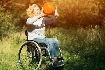 Wheelchair basketball player with ball on his lap