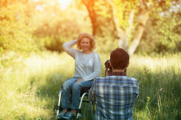 Professianl photographer takes photo of woman in wheelchair