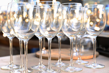 Wine empty transperent glasses in row on bar table.