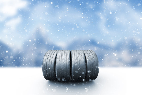 Four car tires on a snow covered road