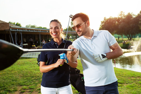 Couple playing golf on a sunny day - Image