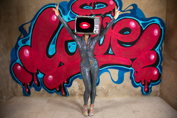 tv head woman and graffiti wall