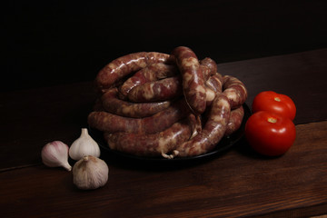 fragrant homemade german sausage cabbage links with meat grinder lay on a plate on wooden table. Sausage allowed with keto diet