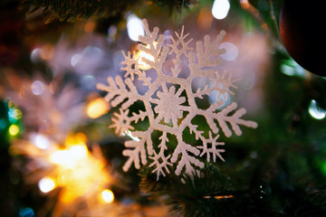 Fototapeta premium Christmas decoration snowflake on the Christmas tree